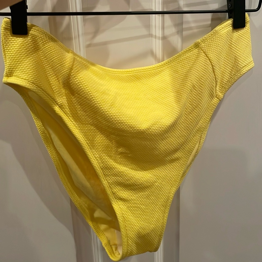 Bright yellow high waisted bikini bottom.